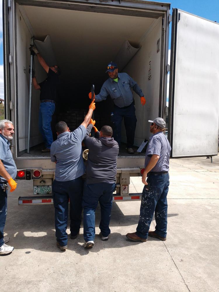 HACL team unloading truck